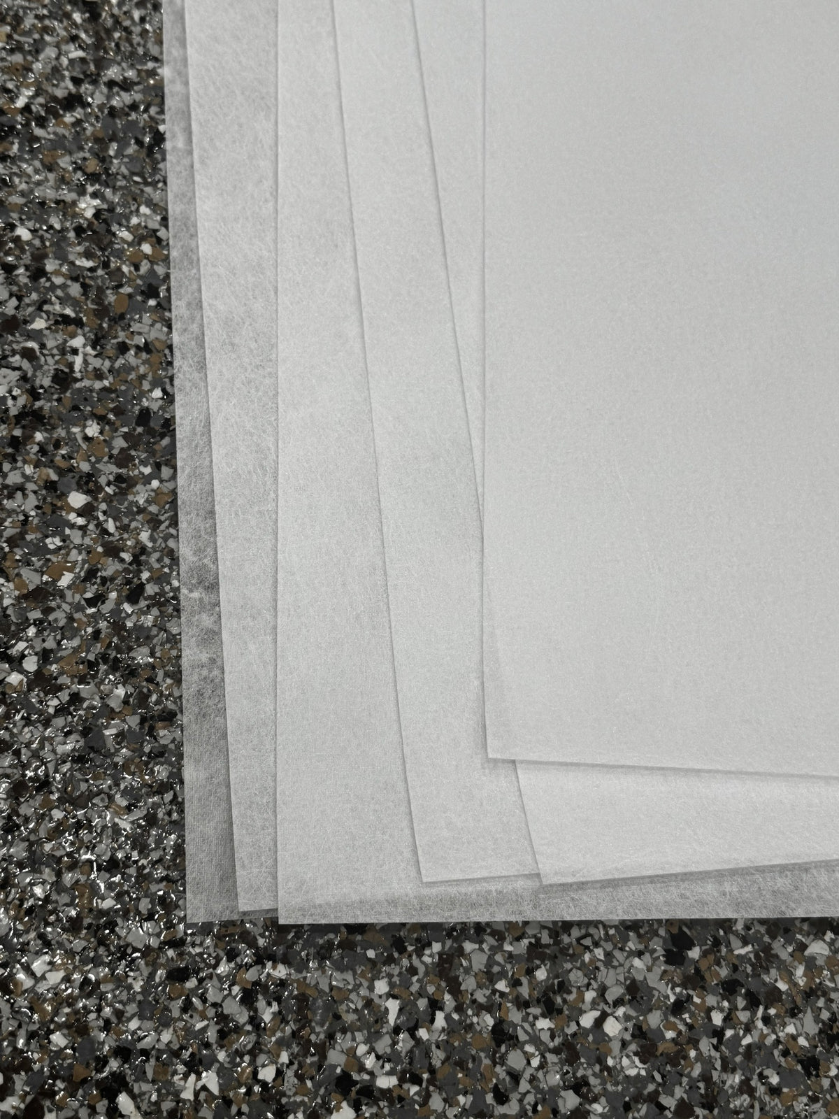 Stacked edges of Reemay flat prefilter sheets showing the thin spunbond polyester